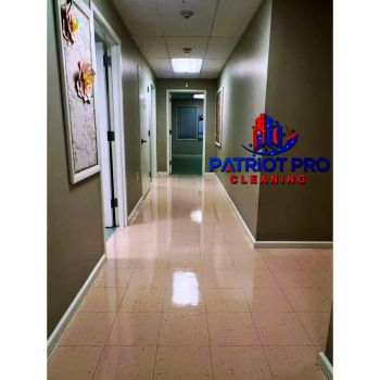 Clean polished hallway in an office building with Patriot Pro Cleaning logo on the wall